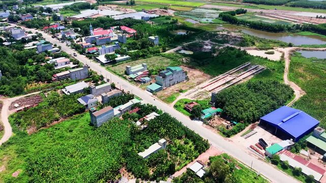 Explore Duc Linh in Lam Dong, Vietnam. The video shows views of fields, a small village, and the landscape from above during daytime. See the greenery and buildings that define the area.