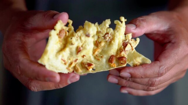 Rempeyek (peyek) is a side dish made from a batter of rice flour, water, coconut milk, and ground spices, topped with peanuts.
