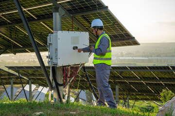 Worker inspecting solar power system equipment outdoors © Zhaorui