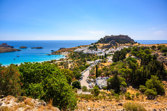 Traditional Lindos Harbor and Whitewashed Village on Rhodes Island, travel destination in Greece;