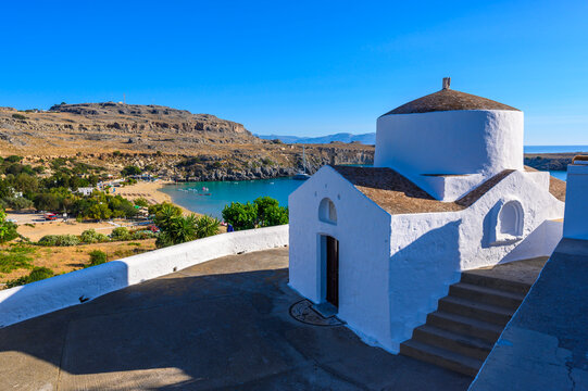 Traditional Lindos Harbor and Whitewashed Village on Rhodes Island, travel destination in Greece;