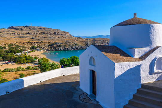 Traditional Lindos Harbor and Whitewashed Village on Rhodes Island, travel destination in Greece;