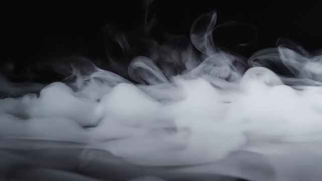 Abstract white smoke swirling on black background with mist fog effect