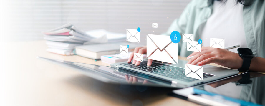 Modern email marketing and digital communication concept showing a professional using a laptop with floating email notifications, message icons, online correspondence