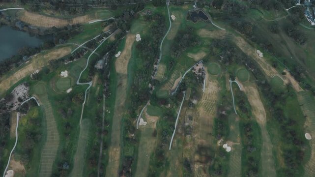 Aerial top-down drone view of a golf course with green fairways