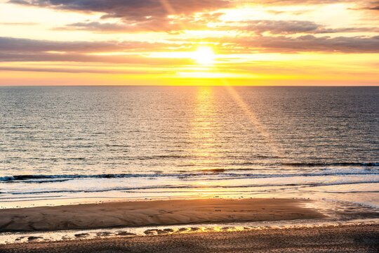 The sun sets over the North Sea beach in Wenningstedt Sylt
