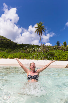 Seychelles, Anse Cocos, female tourist in water