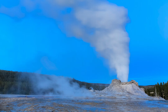 USA, Wyoming, Yellowstone National Park, Upper Geyser Basin, Castle Geyser erupting, blue hour