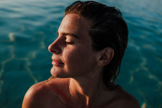 Woman relaxing in the Mediterranean sea during summer vacation