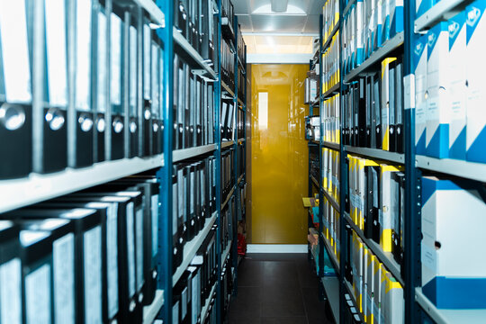 The empty office archive stores business paperwork in a metal shelf