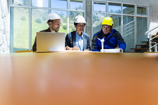 Team of engineers plan a wind farm project in a Loja Ecuador office