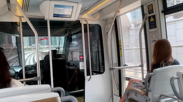 Inside the modern Dubai Tram as it arrives at Sobha Realty Station, showcasing its sleek, contemporary interior design.