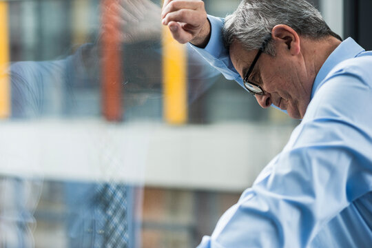 Serious senior businessman at the window 