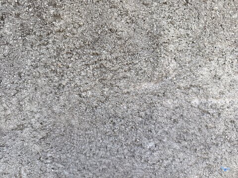 A close-up shot of a weathered concrete surface and rough textures.