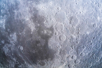 Textured background in the form of the surface of the moon in the night sky close-up. © Alina Yermakova