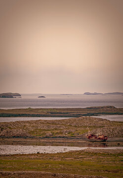 Iceland, Europe: the wreck of a ship on a black beach in the Snaefellsnes peninsula, the western peninsula named Iceland in Miniature for the many sights which can be found in the area