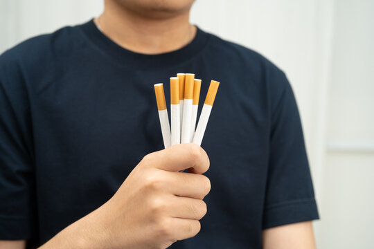 Quit smoking, Asian teenage man breaking destroy cigarette in hand.