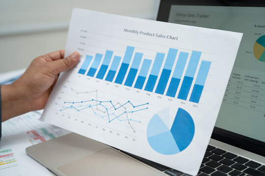 Asian business woman working with financial graph.