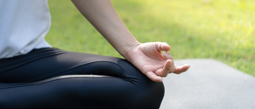 woman practicing meditate on the park. Asian woman doing exercises in morning. balance, recreation, relaxation, calm, good health, happy, relax, healthy lifestyle, reduce stress, peaceful, Attitude.