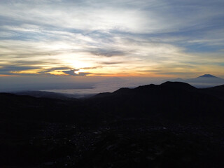 Fototapeta premium Aerial Drone View of Sunrise Between Mountain Ranges with Peaceful Morning Landscape 