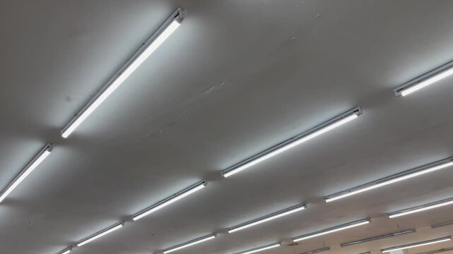 Symmetrical view of parallel linear LED lights on modern ceiling