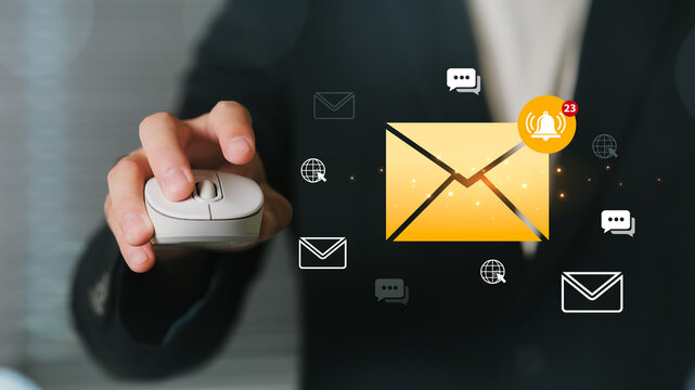 Business professional using a computer mouse in a modern workspace, interacting with animated email alert icons and notification symbols indicative of digital communication