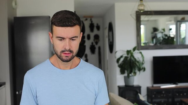 Thoughtful man reading paper document at home before standing and leaving