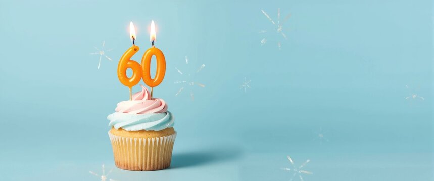 Cupcake with Pink and Blue Frosting Topped with 60 Birthday Candles on Light Blue Background