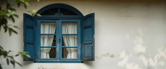 Obraz premium Blue Wooden Window with Open Shutters and White Curtains on a Wall