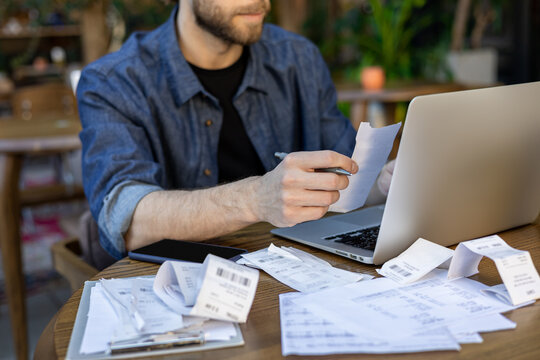 Close-up of man holding receipt