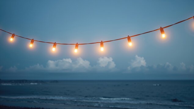 String Lights Illuminating Beach at Dusk with Calm Ocean View