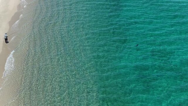 Aerial view of a fly fisherman on the beach casting into the Sea of Cortes in La Ventana, Mexico.