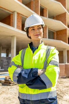 Inspired female professional wearing safety hardhat standing