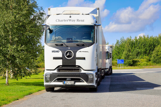 Custom white Mercedes-Benz Actros L GigaSpace ProCabin 2553 semi-truck and trailer parked on the truck stop yard.