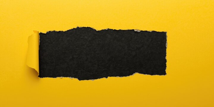 Torn Black Paper on Yellow Background - Close-Up, Dynamic Contrast, Text Space