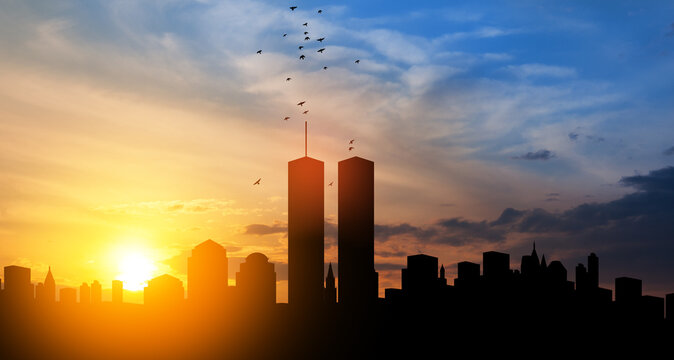 New York skyline silhouette with Twin Towers and birds flying up like souls at sunset. American Patriot Day banner.