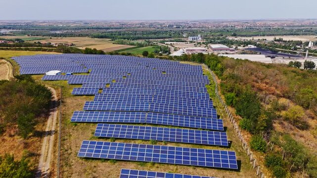 Aerial view of solar farm with rows of photovoltaic panels set in a rural landscape near Beocin, Vojvodina, Serbia.