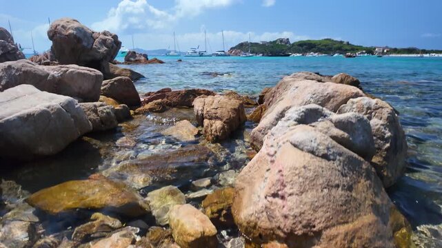 Panoramic view of the turquoise bay with yachts and boats off the coast of Santa Maria Island in the La Maddalena archipelago, Sardinia, Italy