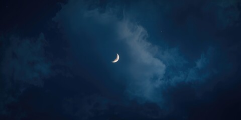 Fototapeta premium Crescent Moon Glowing Among Dark Clouds at Night