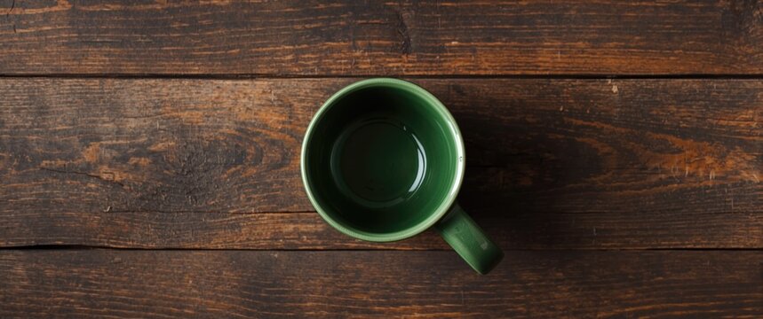 Green Coffee Mug on Rustic Wooden Table from Above