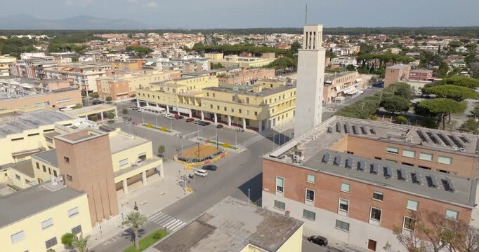 Aerial view of the municipal tower in Piazza del Comune, in Sabaudia, in the province of Latina, in Lazio, Italy. The rationalist architecture dates to the 1930s, captured in a sunny summer day.