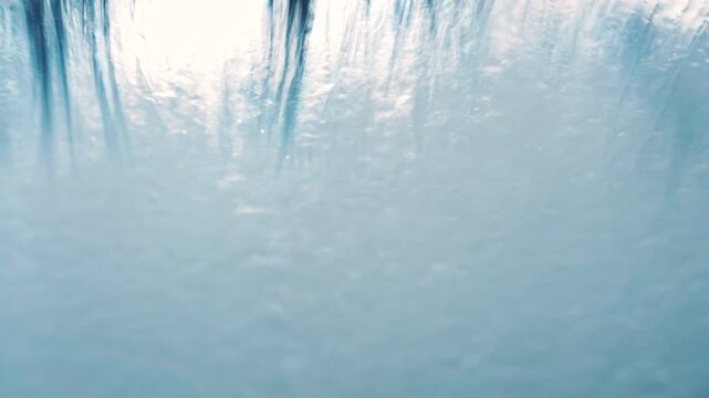 Bristle Brush Sweeping Foam and Mist Across Glass in Abstract Motion