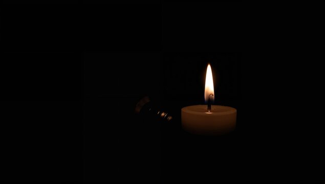 Candle Flame Flickering in Darkness with Soft Warm Glow
