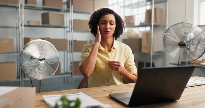 Hot, fan and woman with laptop in warehouse for distribution, logistics and ventilation problem. Small business, tech and air flow appliance for HVAC issue, heat and hyperhidrosis or supplier stress