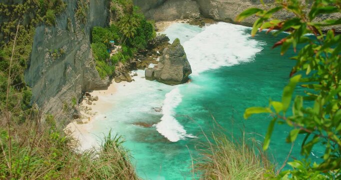 Turquoise ocean bay with white sand beach and rocky formations in Nusa Penida Bali Island Indonesia