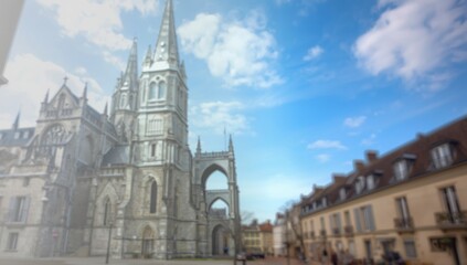 Naklejka premium Historic Stone Cathedral with Towers Against a Blue Sky and Cloudscape