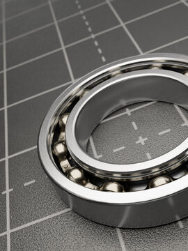 Close-up view of a ball bearing with its internal components visible on a grid surface