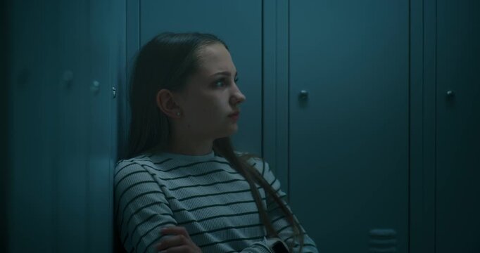 Young Girl Sitting Alone by School Lockers While Processing Emotions After Difficult Day. Concept of Mental Health, Academic Pressure, Emotional Wellbeing and Resilience in Modern School Life.