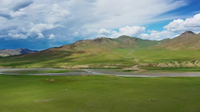 Aerial view of the Orkhon Valley Natural and Historical Reserve with rolling green hills and a winding river in Xarxorin, Ovorkhangai, Mongolia.