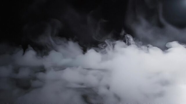 Thick white smoke or fog on black background with soft swirling patterns and misty atmosphere